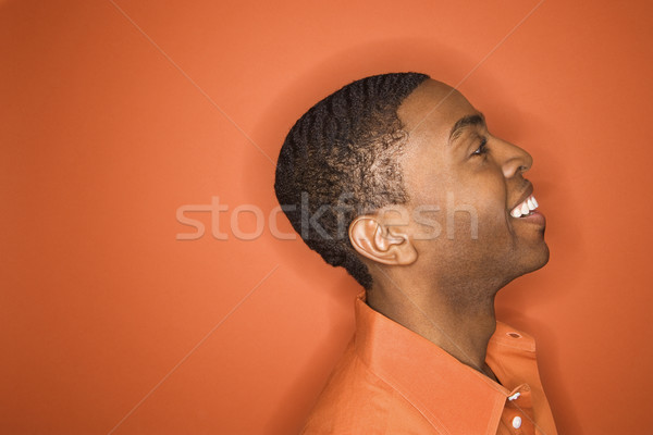 Stockfoto: Jonge · man · zijaanzicht · glimlachend · jonge · man · oranje