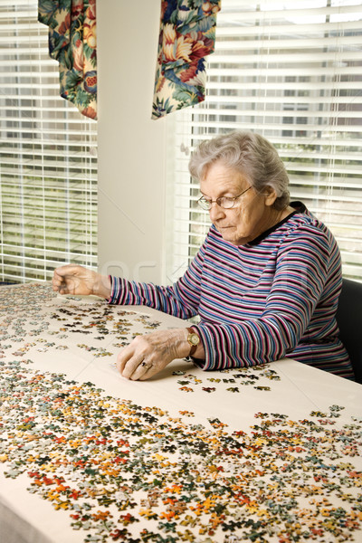 Stock photo: Elderly Woman Doing Jig Saw Puzzle