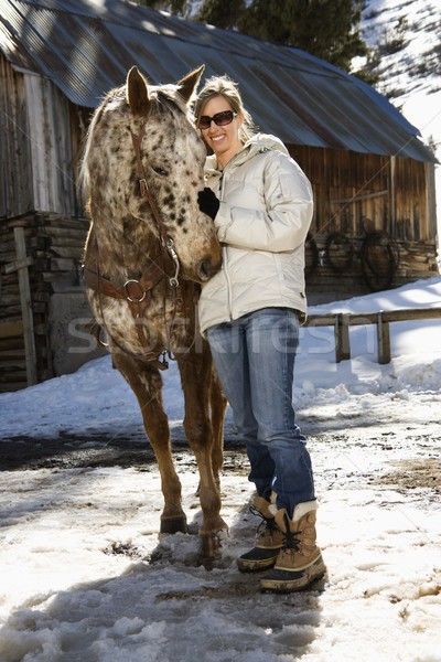 Woman petting horse. Stock photo © iofoto