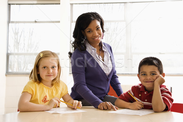 Teacher Helping Students With Schoolwork  Stock photo © iofoto