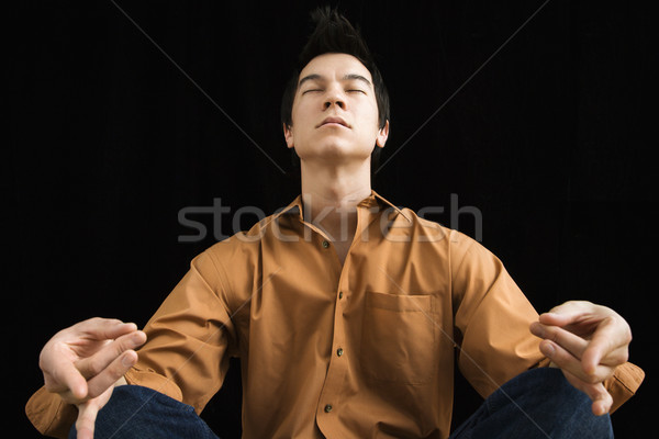 Homem sessão meditando asiático moço lótus Foto stock © iofoto