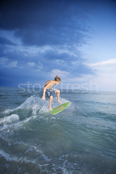 Boy riding skimboard. Stock photo © iofoto