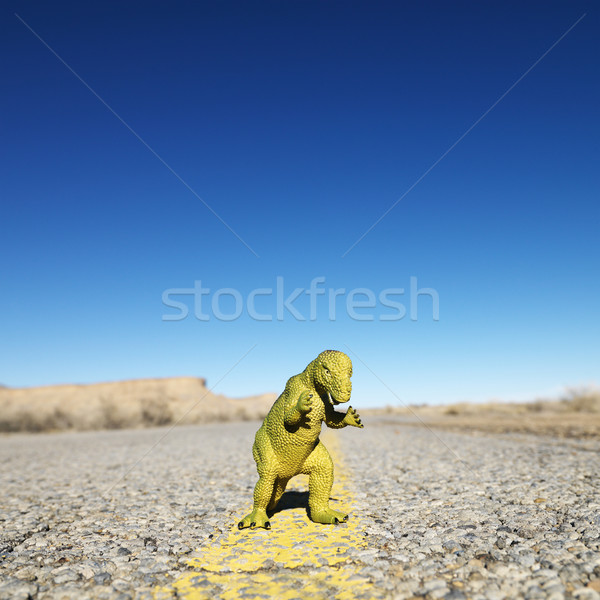 Toy dinosaur in road. Stock photo © iofoto