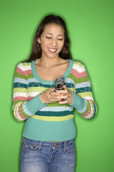 Teen girl using cellphone. Stock photo © iofoto