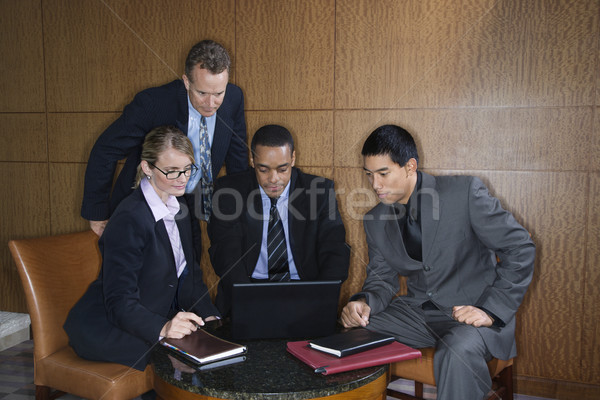 Businesspeople Gathered Around a Laptop Stock photo © iofoto