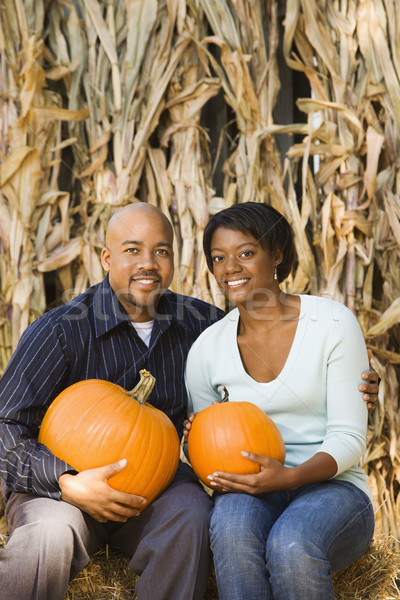 Couple holding pumpkins. Stock photo © iofoto