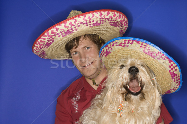 Dog and man wearing sombreros. Stock photo © iofoto