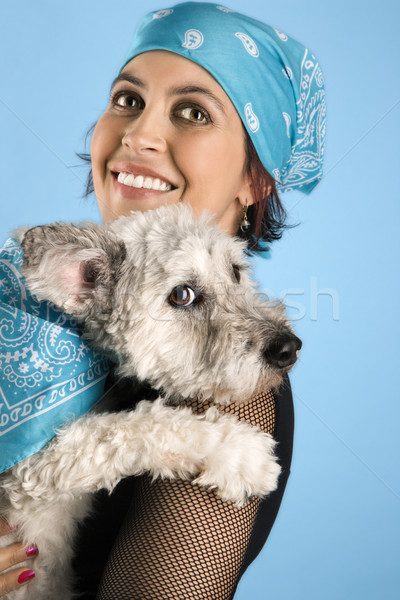 Smiling young woman holding dog. Stock photo © iofoto