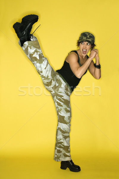 Young woman kicking. Stock photo © iofoto