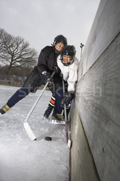 Boys playing ice hockey. Stock photo © iofoto