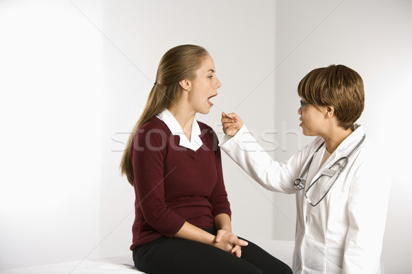 Doctor examining patient. Stock photo © iofoto
