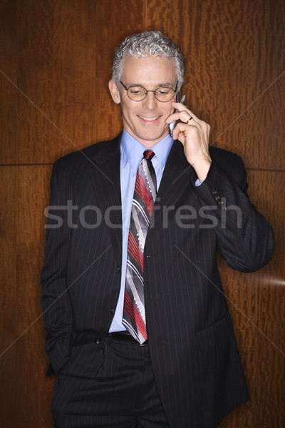 бизнесмен улыбаясь говорить мобильного телефона вертикальный Сток-фото © iofoto