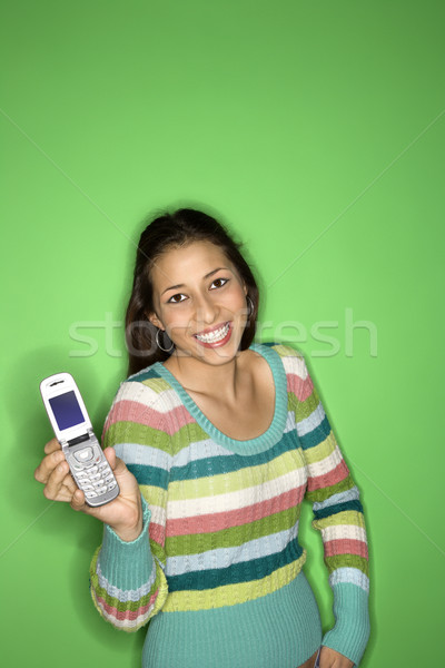 Teenage girl holding cellphone. Stock photo © iofoto