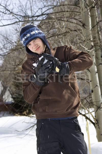 Teenager making snowball Stock photo © iofoto
