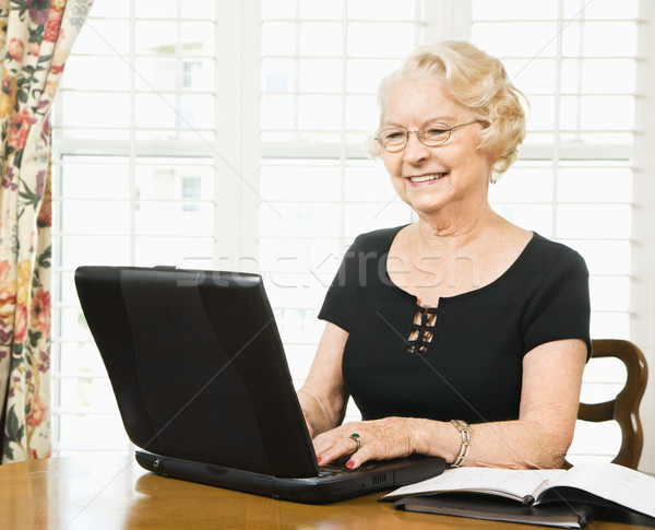 Mature woman with laptop. Stock photo © iofoto