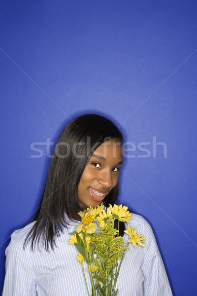 Girl holding flowers. Stock photo © iofoto