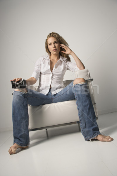 Young Woman Sitting on Chair and Holding Camera Stock photo © iofoto