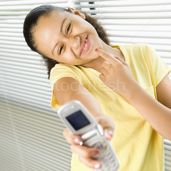 Girl holding phone. Stock photo © iofoto