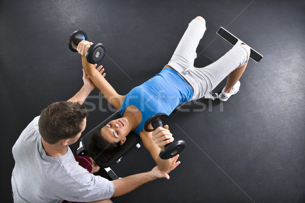Woman lifting weights Stock photo © iofoto