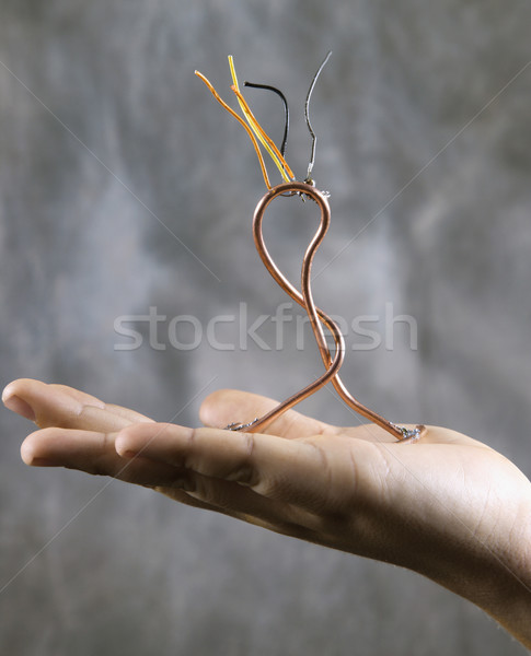 Boy's hand holding wire sculpture. Stock photo © iofoto