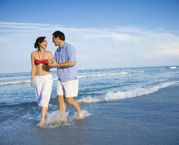 Couple walking on beach. Stock photo © iofoto