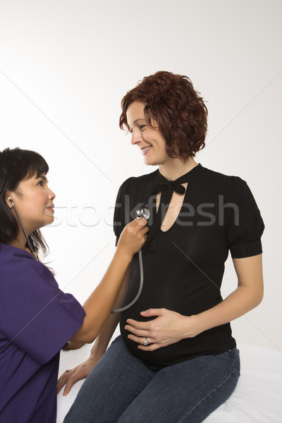 Pregnant woman at doctor. Stock photo © iofoto