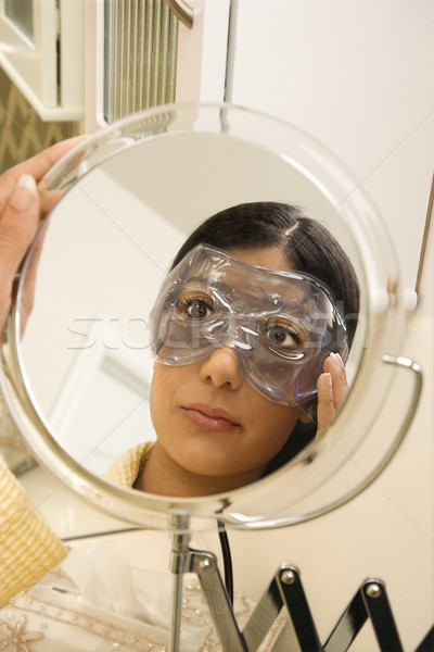 Young woman wearing eye mask. Stock photo © iofoto