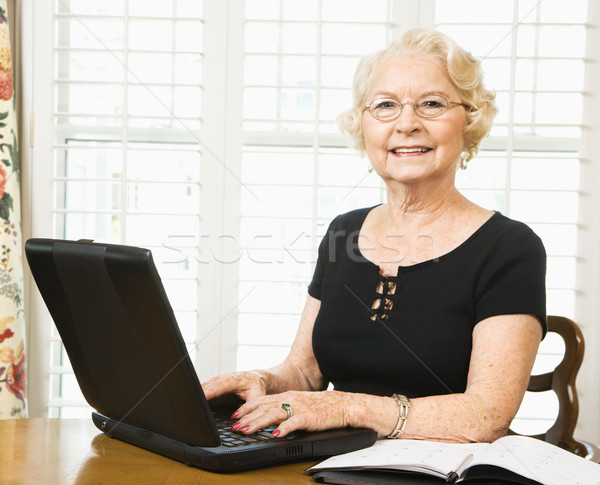 Mature woman with laptop. Stock photo © iofoto