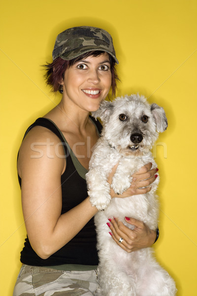 Smiling pretty woman holding dog. Stock photo © iofoto