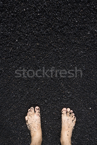 Barefeet in black sand. Stock photo © iofoto