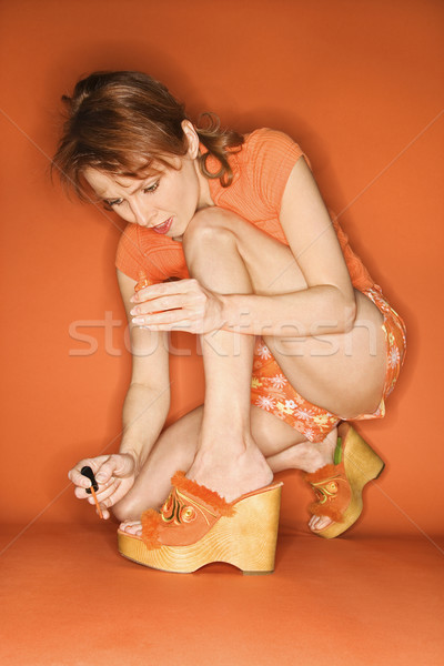 Stock photo: Woman painting toenails.