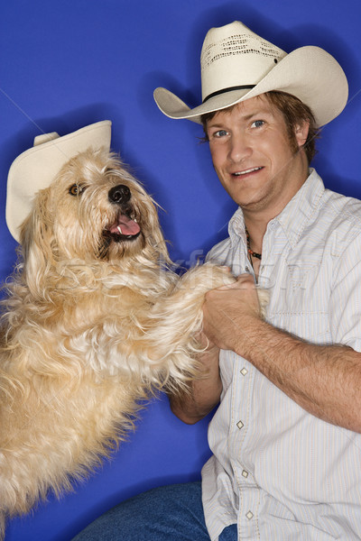 Dog and man in cowboy hats. Stock photo © iofoto
