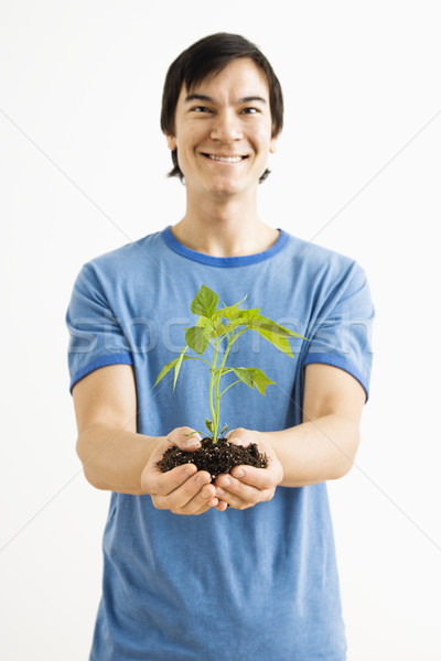 Sorridente homem planta asiático em pé Foto stock © iofoto