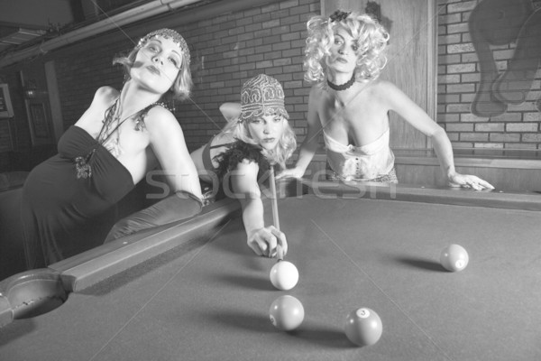 Stock photo: Retro females shooting billiards.