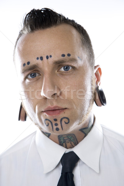 Adult male with tattoos and piercings. Stock photo © iofoto