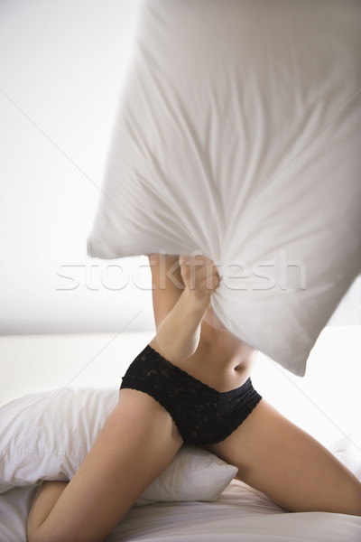Frau Kissen kämpfen kniend Bett schwarz Stock foto © iofoto