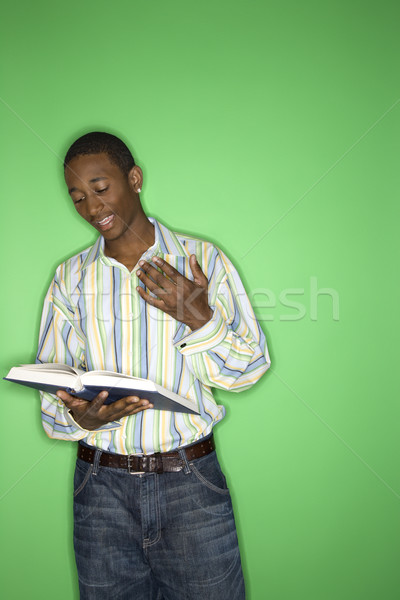 Teen boy reading book. Stock photo © iofoto