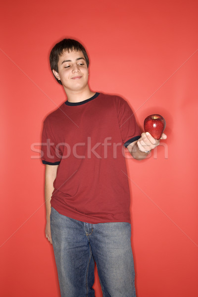 Teen boy holding apple. Stock photo © iofoto