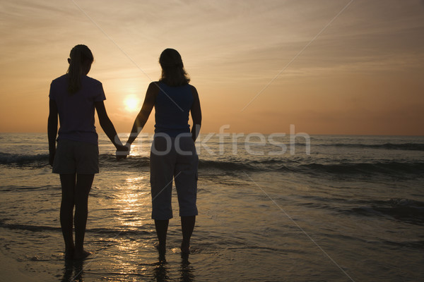 Mom and daughter at sunrise. Stock photo © iofoto