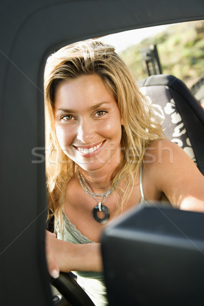 Uśmiechnięta kobieta posiedzenia samochodu portret kobiet Zdjęcia stock © iofoto