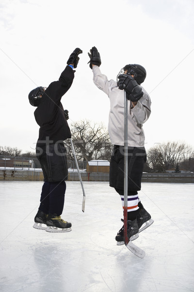 Stock photo: Hockey players high fiving.