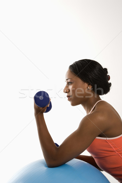 Profile woman lifting dumbbell. Stock photo © iofoto