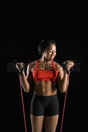 Woman stretching resistance tube. Stock photo © iofoto