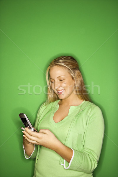 Girl using cellphone. Stock photo © iofoto