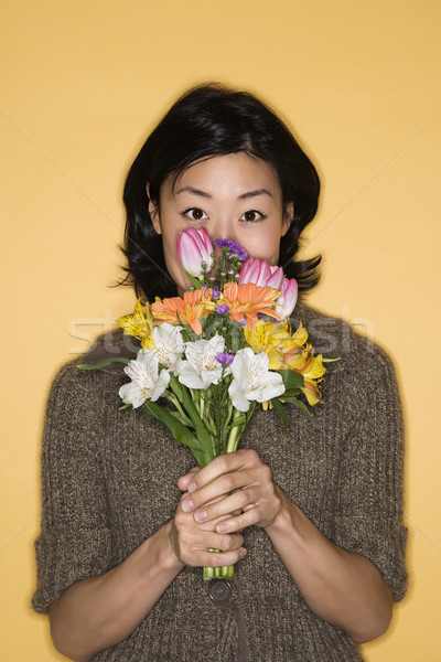 Woman holding flowers. Stock photo © iofoto