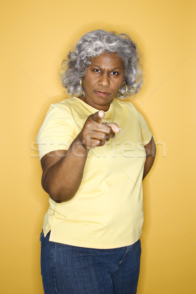 Woman sternly pointing at viewer. Stock photo © iofoto