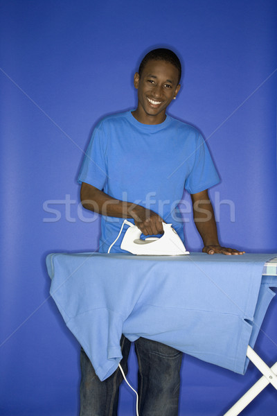 Teen boy doing chores. Stock photo © iofoto