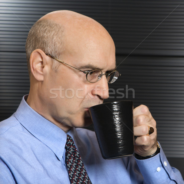 Businessman drinking coffee. Stock photo © iofoto