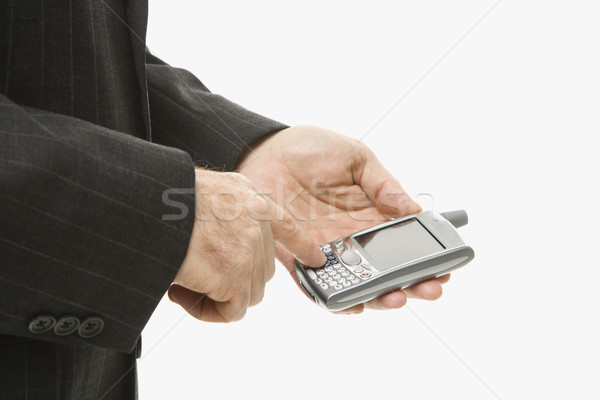 Stock photo: Businessman using PDA.
