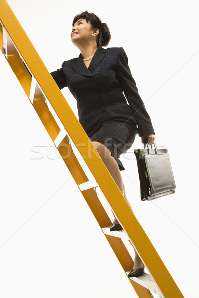 Stock photo: Businesswoman climbing ladder.